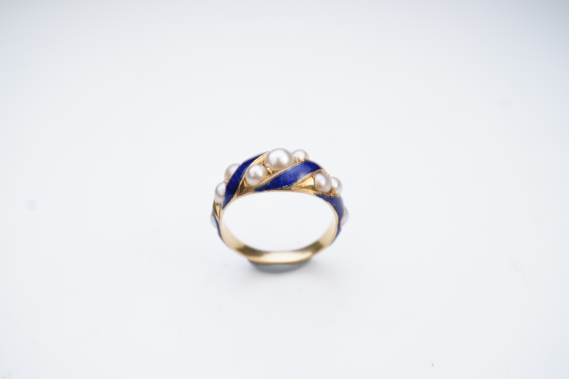 A Victorian half pearl and blue enamel ring, mid 19th century
